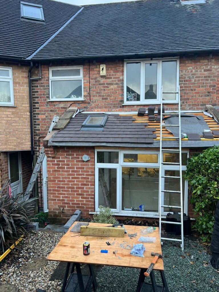 This is a photo of a roof extension that is having new roof tiles installed. This is a photo taken from the roof ridge looking down a tiled pitched roof on to a flat roof. Works carried out by Foots Cray Roofing Repairs