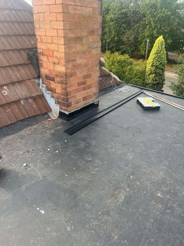 This is a photo of a flat roof which has just been repaired, there is also a chimney stack and some leadwork has also been dressed. Works carried out by Foots Cray Roofing Repairs